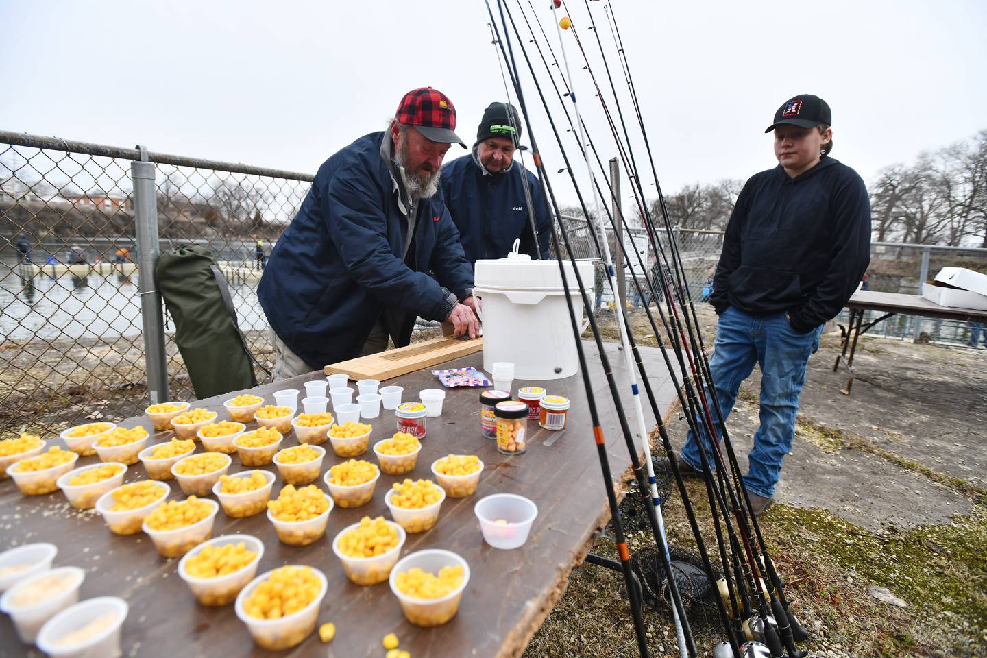Participant Karson Reynolds, 12, right, of Bourbonnais, awaits the measurement of his first catch by Northern Illinois Anglers Association's vice president Bob Anderson, left, and board member Jeff Enfield, during the return of the group's popular Kids Fishing Day at the Bird Park quarry in 2022.