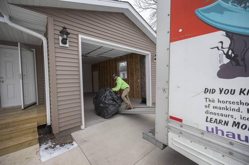 Tyler Stubblefield unloads items to his friend Megin Steeb’s new Habitat for Humanity home Sunday, Dec. 22, 2024, in Dixon.