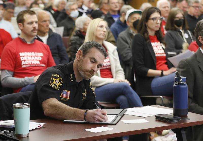 McHenry County Sheriff Robb Tadelman takes notes as he listens to public comments at the McHenry County's Law and Government Committee meeting on Tuesday, Jan. 31, 2023, at the McHenry County Administration Building. The committee held a public comment period before it considered a resolution to oppose Illinois' newest gun ban and support its repeal.