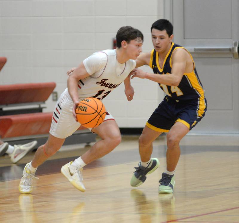 Forreston's Kendall Erdmann (13) heads to the basket as Polo's Jordan Reed (14) defends on Tuesday, Jan. 7, 2024 at Forreston High School. Erdmann led all scorers with 32 points.