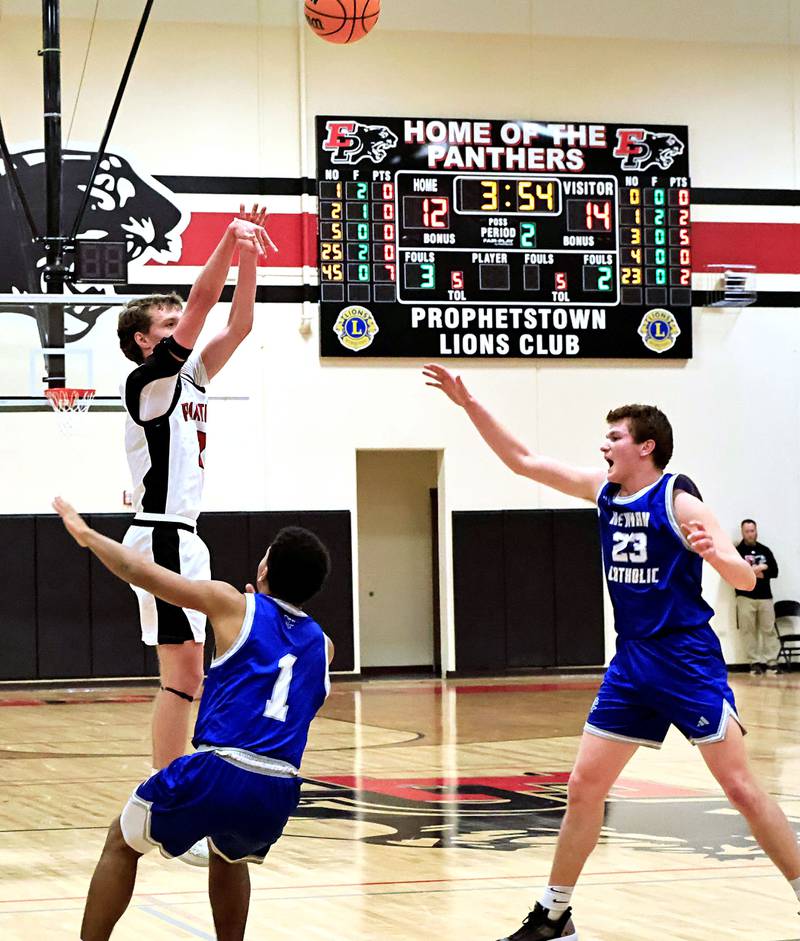 EP’s Connor Keegan leaps above Newman's Tyson Williams (left) and John Rowzee to sink a 3 point shot putting the Panthers ahead of the Comets for the first time during the Wednesday, Jan. 28, 2026, contest  in Prophetstown. The Panthers and Comets went back and forth the entire game, with the Comets coming out on top  57-49.