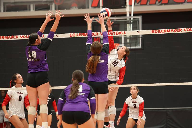 Bradley-Bourbonnais' Olivia Woolman hits as Manteno's Maddie Gesky, left, and Emily Horath jump to block during the Panthers' victory in three sets, 25-21, 23-25, 25-17, over the Boilermakers on Monday, Sept. 15, 2025.
