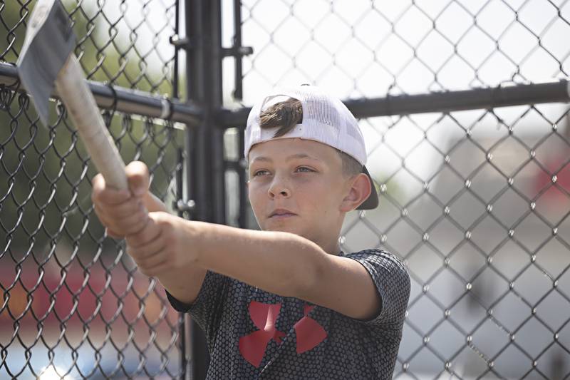Kyhlor Thomas, 10, of Tampico takes aim at the Whoop Your Axe booth Saturday, July 22, 2023 at Tampico Days.