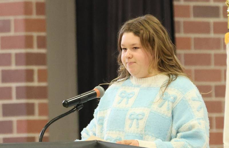 Parkside Middle School student Natalie Rebholz, reads her poem "The Brave One" during the Veterans Day program on Tuesday, Nov. 11, 2025 in Peru.