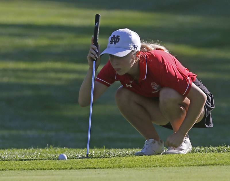 Dundee-Crown’s Sophie Morawski lines up a putt on the10th green during the Fox Valley Conference Girls Golf Tournament Wednesday, Sept. 25, 2024, at Crystal Woods Golf Club in Woodstock.