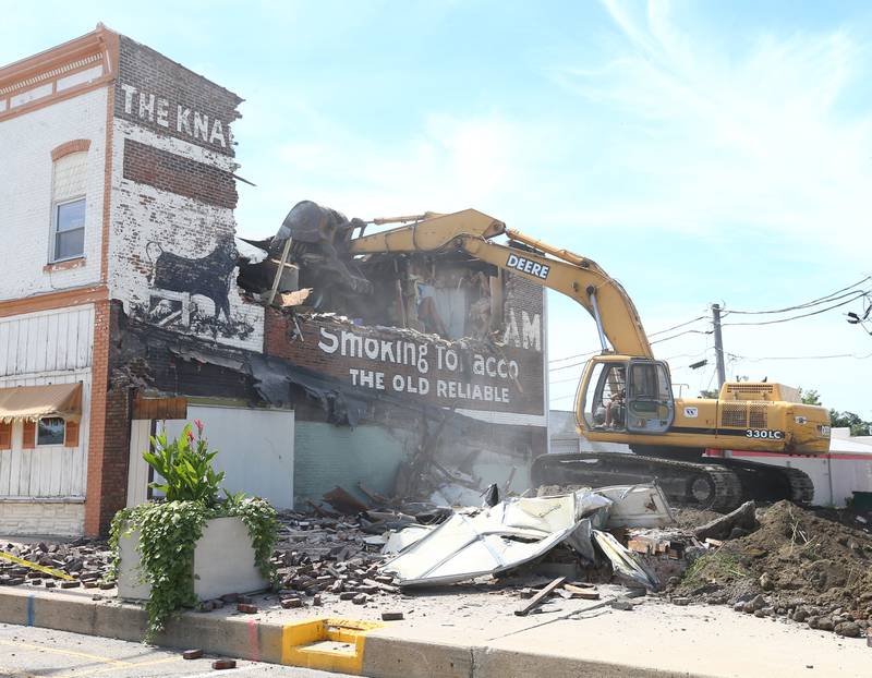 An excavator demolishes the Genuine "Bull Durham Smoking Tobacco mural located in the looked  800 block of Main Street on Thursday, Sept. 1, 2022 in Mendota. On Aug. 22, 2022 nineteen fire departments from all over the Illinois Valley battled a apartment fire that destroyed the entire block.