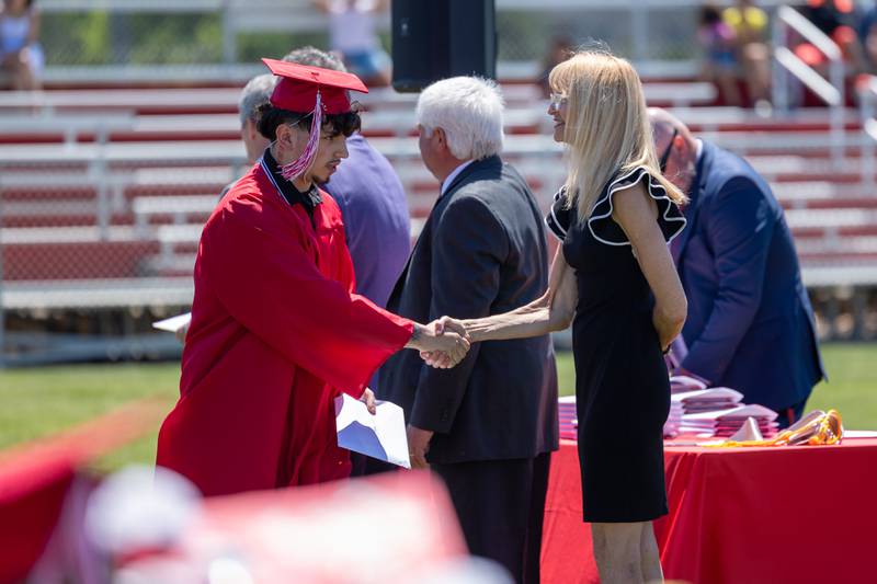 Brayden Perez shakes hand of administrator after graduating on Sunday, May 18, 2025 at Hall High School in Spring Valley.