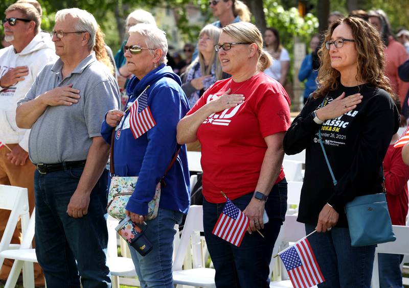 Attendees put their hands on their hearts during the singing of the “Star Spangled Banner” Monday, May 26, 2025, during the Memorial Day ceremony at Ellwood House in DeKalb.