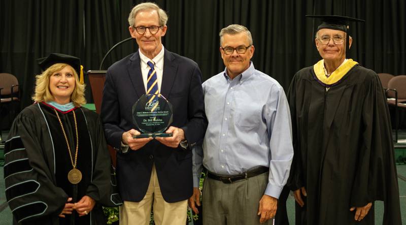 (Left to right); Kishwaukee College president Laurie Borowicz, Bill Nicklas, Frank Roberts, and Kishwaukee College board of trustees chair Bob Johnson