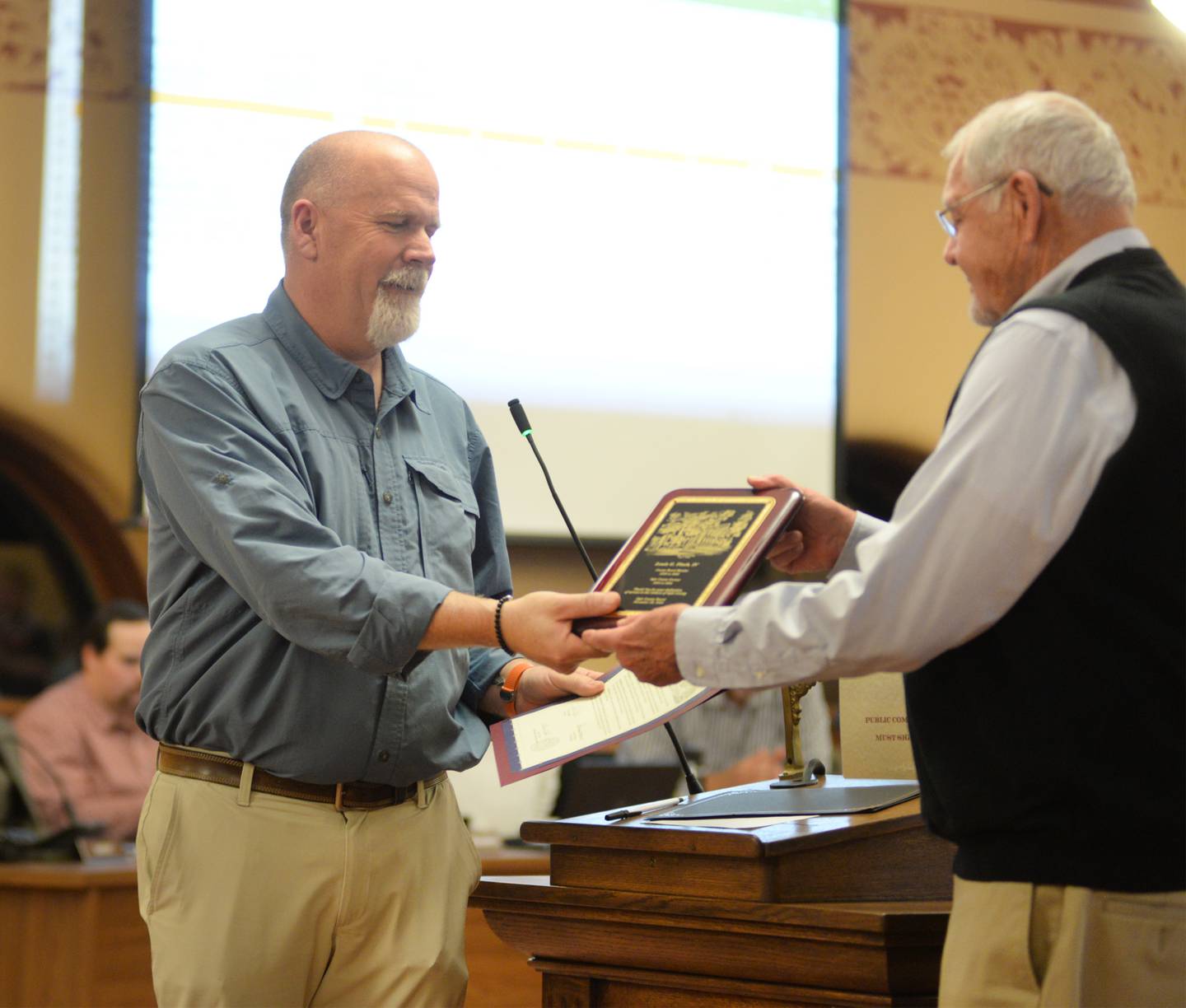 Retiring Ogle County Coroner Lou Finch (left) of Mt. Morris, receives his certificate of appreciation from Board Chairman John Finfrock (right) at the Ogle County Board meeting on Tuesday, Nov. 19, 2024. Finch has served as coroner since 2004 and chose not to run for reeletion this year.