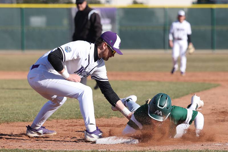 Joliet Junior College’s Brendan Sturm attempts a pickoff tag on Moraine Valley’s Maxwell Hensler on Tuesday, March 7th, 2023.
