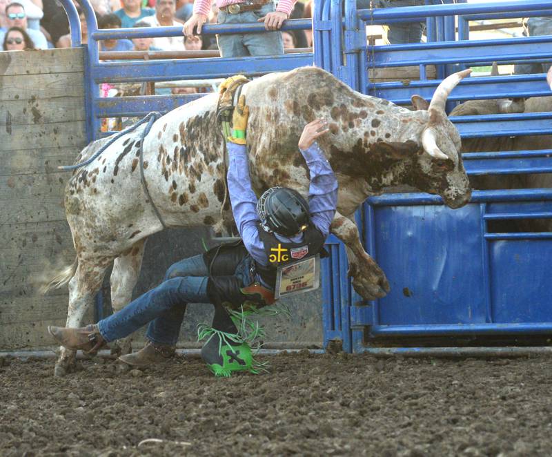Hunter Sale finds himself on the wrong side of a bull during the rodeo at the Lee County Fair on Saturday, July 29, 2023.