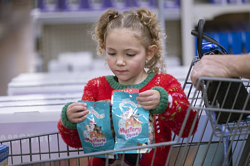 Amelia Seldon, 6, checks out a few gift selections Saturday, Dec. 9, 2023 during Dixon police's Shop with a Cop.