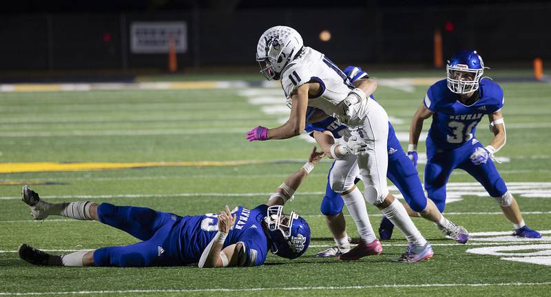 The Newman defense wraps up Monmouth-Roseville’s Payton Thompson Friday, Oct. 25, 2024, at Roscoe Eades Stadium in Sterling.