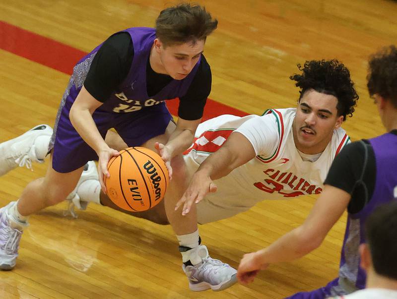 Dixon's Jimi Gosinski grabs a loose ball as L-P's Marion Persich dives late to the play during the Class 3A Regional semifinal game on Wednesday, Feb. 25, 2026 in Sellett Gymnasium at L-P High School.