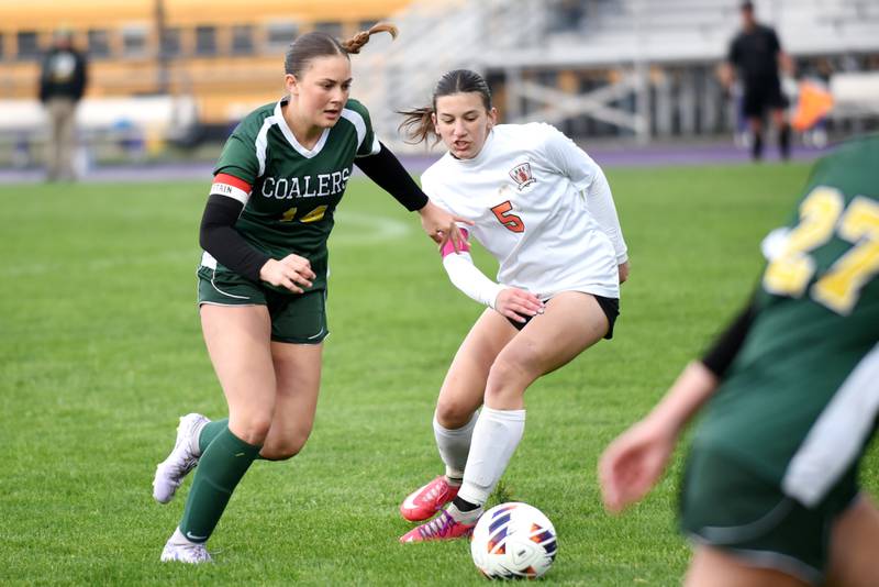 Coal City's Kylee Kennell, left, works her way around Beecher's Teagan Klaus during the Class 1A Manteno Regional championship Tuesday, May 20, 2025.