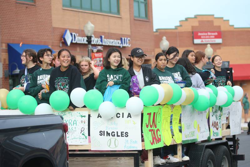 St. Bede girls tennis players ride on a float during the St. Bede Homecoming parade on Friday, Sept. 27, 2024 downtown Peru.