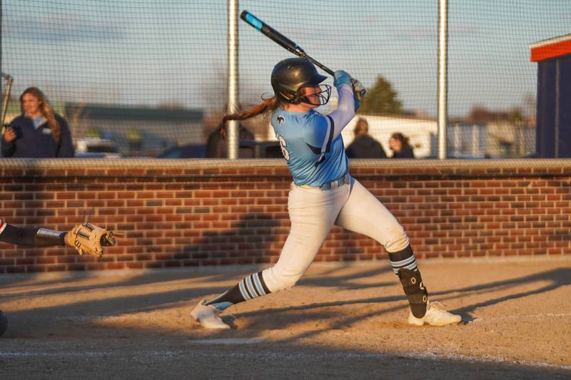 Downers Grove South's Ella Cushing (16) hits a two run homer against Oswego during a softball game at Oswego High School on Tuesday, March 19, 2024.