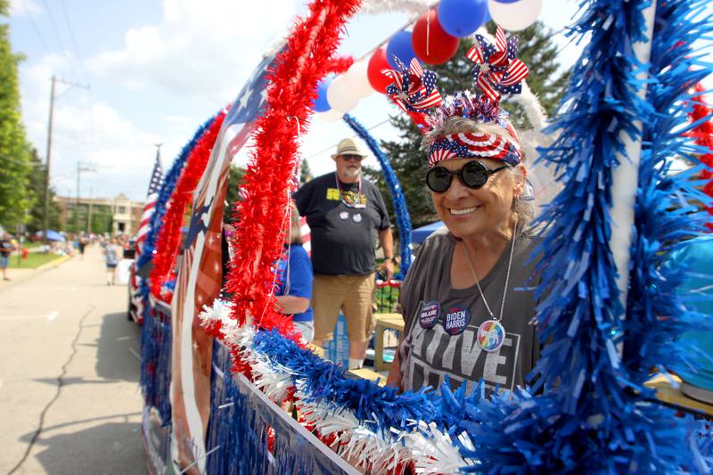 Sarah Trost rides the McHenry County Democratic Party float as part of the Fiesta Days parade along Main Street in McHenry Sunday.