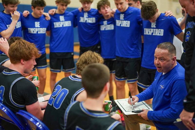 St. Charles North's head coach Tom Poulin talks to his players before the start of the second quarter during a basketball game against Geneva at Geneva High School on Wednesday, Feb 14, 2024.