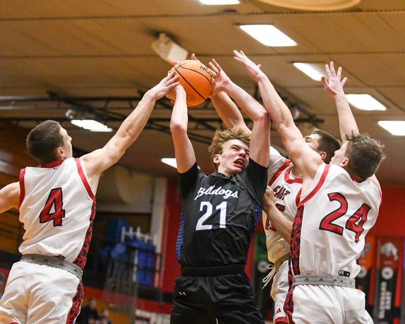 Riverside Brookfield's Colin Cimino (21) goes up for a shot during the game while being defended by Glenbard East players on Friday Dec. 19, 2025, held at Glenbard East High School.