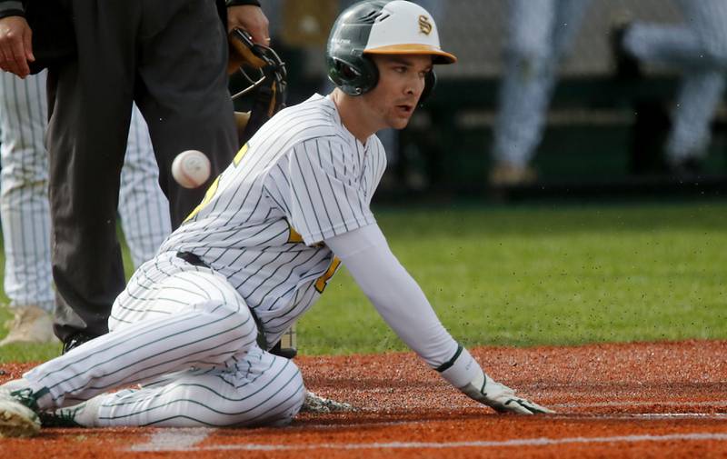 Crystal Lake South's Yandel Ramirez slides into to home to score a passed ball during a Fox Valley Conference baseball game against Hampshire on Monday, April 29, 2026, at Crystal Lake South High School.