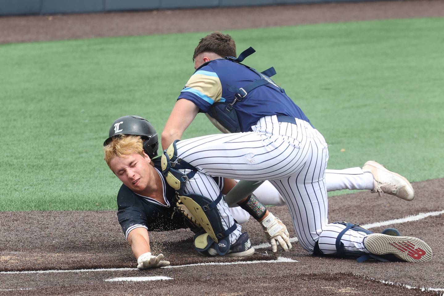 Ottawa Marquette’s Keaton Davis tags out Lexington’s Cooper Miller at home plate during the Crusaders' 16-1 victory over Lexington in the IHSA Class 1A State semifinal on Friday, June 6, 2025.
