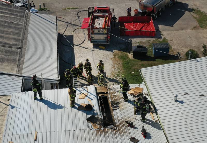 An aerial view of firefighters on top of a roof at Grassers Heating and Plumbing on Wednesday, Sept. 17, 2025 in McNabb. The fire began shortly before 10a.m. A Mutual Aid Box Alarm System (MABAS) was elevated to the fourth-alarm. No one was injured in the fire. Fire departments from McNabb, Peru, Utica, Henry, Ladd, Hennepin, Granville, Oglesby, Spring Valley, Leonore, Troy Grove, Seatonville, Wenona, Standard, Lacon-Sparland, Bureau and Tonica all responded to the scene. Firefighters left the scene at 11:30a.m.