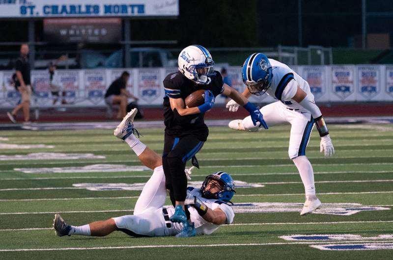 St. Charles North's Jake Mettetal (4) runs after the catch against Lake Zurich during a football game at St. Charles North High School on Friday, Sep 2, 2022.