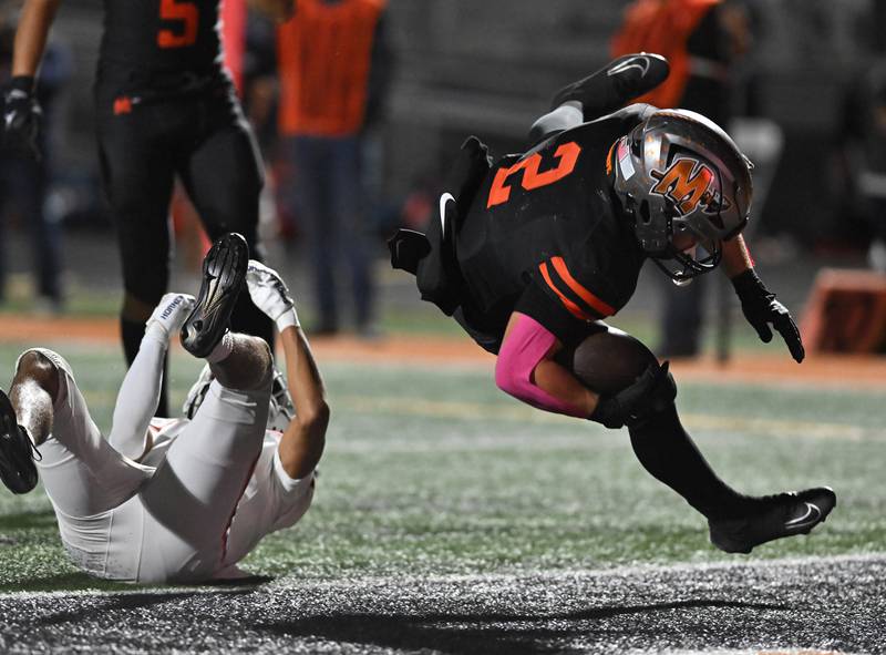 Minooka's Chase Nurczyk (2) goes airborne for a first half touchdown during the conference game against Oswego on Friday, OCT. 10, 2025, at Minooka.