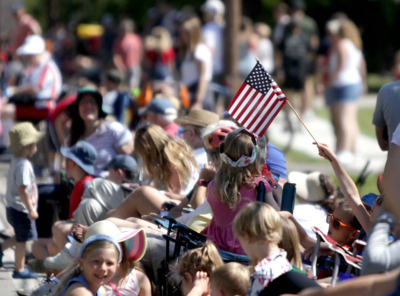 Onlookers wait along Warrenville Road in Wheaton for the annual Memorial Day Parade on Monday, May 29, 2023.