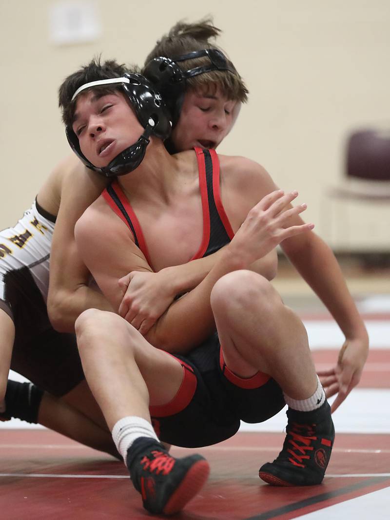 Huntley’s Noah Gutierrez tries to get out of the grasp od Jacobs’ Travis Wilgosiewicz during the 106—pound match of a Fox Valley Conference wrestling meet on Thursday, Dec. 11, 2025, at Huntley High School.