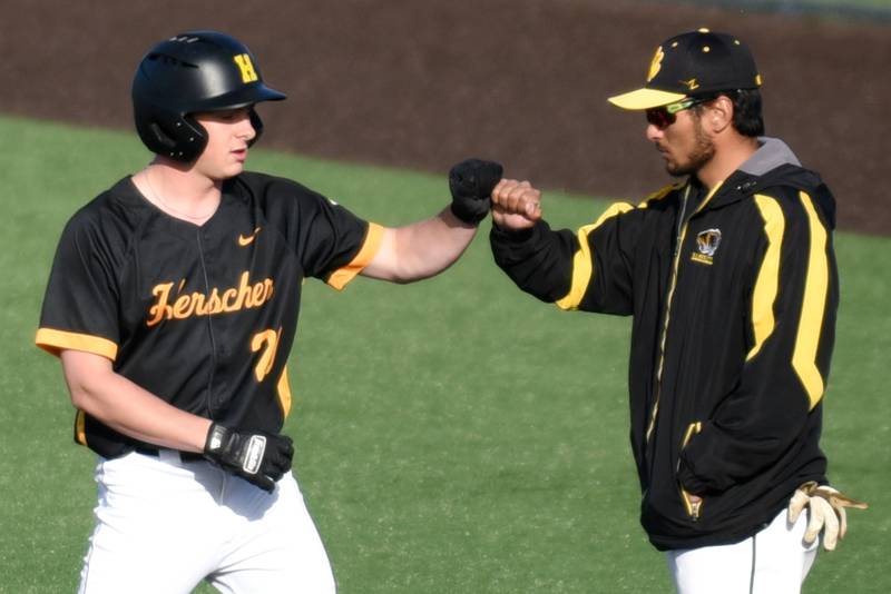 Herscher's Gaige Brown, left, fist bumps Tigers assistant Austin Headrick after hitting a single during a home game against Manteno Monday, May 11, 2026.