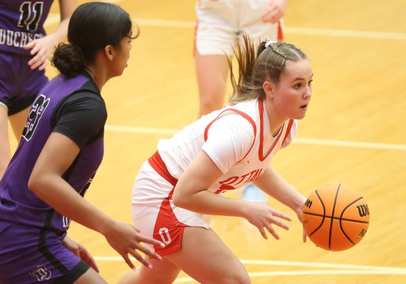 Ottawa's Hailey Thrush looks to pass the ball off as Dixon's Ahmyrie McGowan defends on Wednesday, Dec. 3, 2025 in Kingman Gymnasium at Ottawa High School.