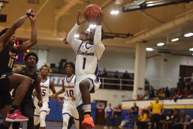 Joliet Central’s Jamarcho Holman puts up a shot against Joliet West.
