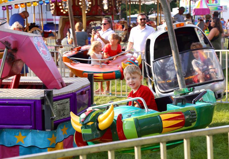 Huxley Ames, 4, of Aurora rides a spaceship at the 2024 Sugar Grove Corn Boil on Friday, July 26, 2024.