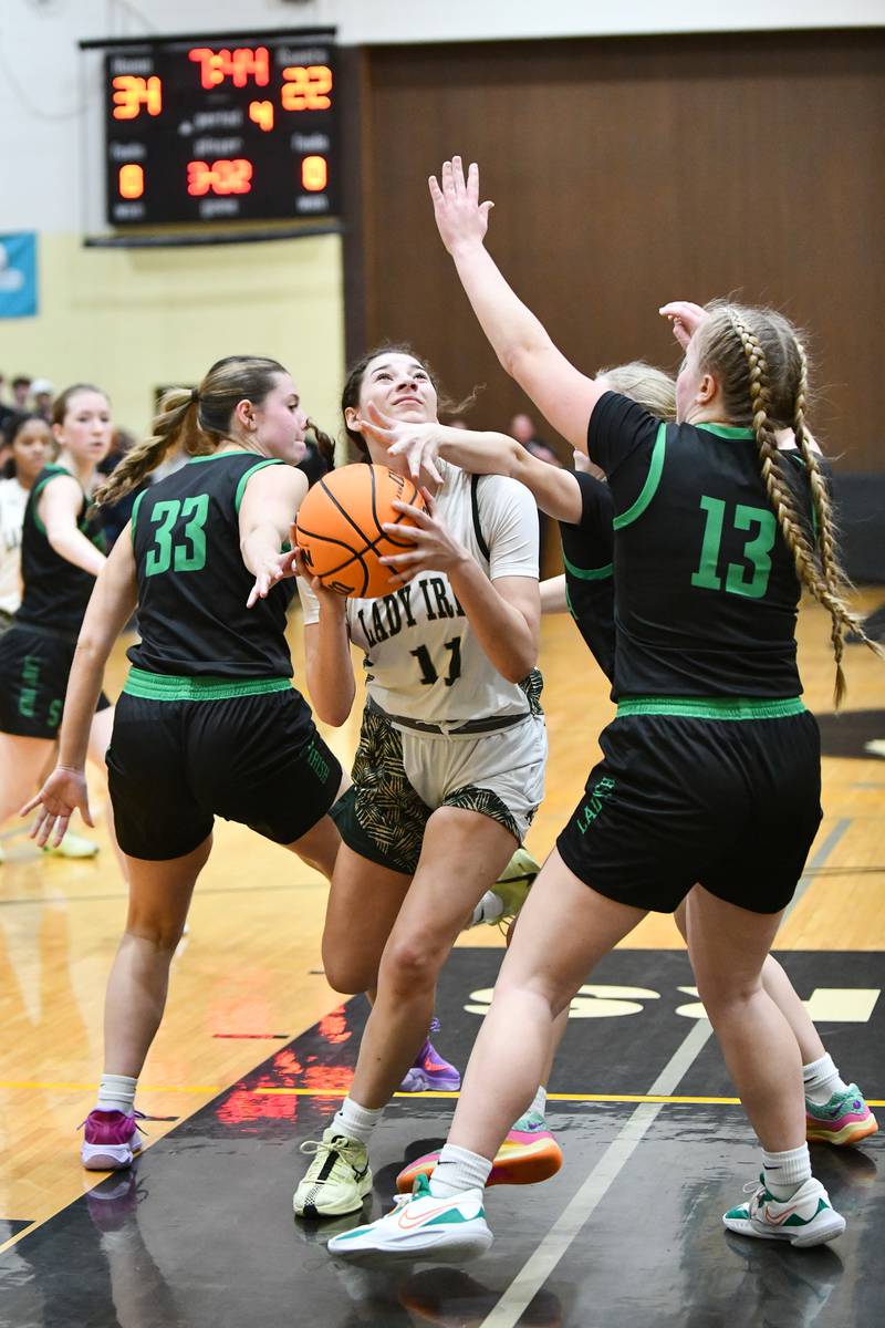 Bishop McNamara's Trinity Davis draws a foul as she drives to the basket Tuesday, Feb. 25, during the Fightin' Irish's 51-30 victory over Seneca in the IHSA Class 2A Herscher sectional semifinal.