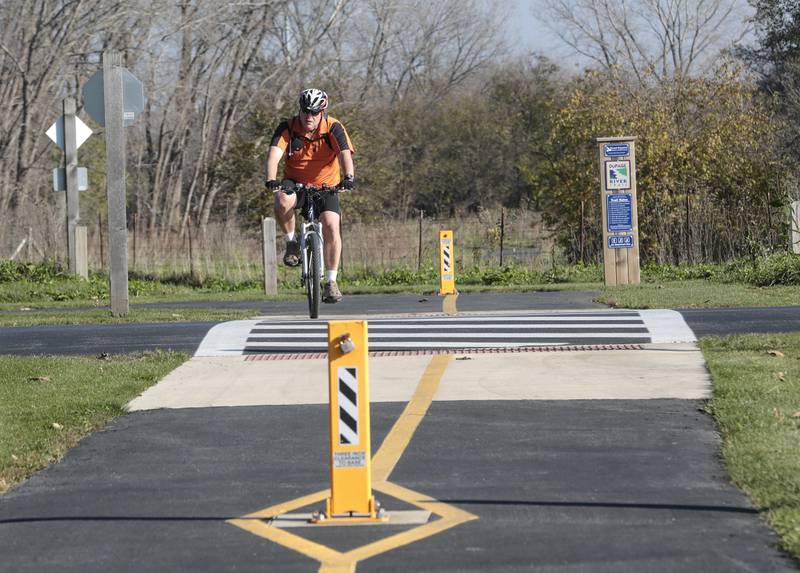 A bicyclist rides through Hammel Woods on Wednesday, Nov. 16, in Joliet.