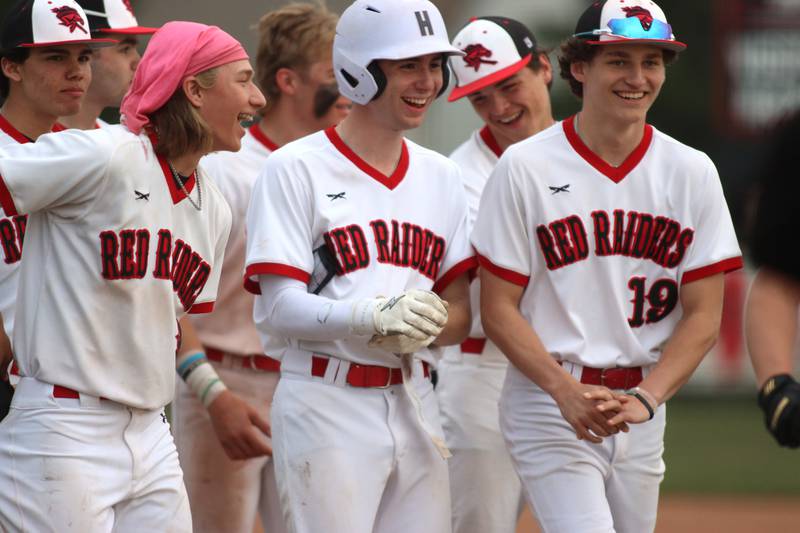 Huntley’s Red Raiders are all smiles after an 11-1 win over Jacobs in varsity baseball Wednesday at Huntley.