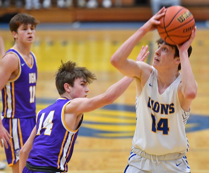 Lyons Township's Connor Carroll (right) starts to shoot as Downers Grove North's Maxwell Haack defends during a game on Jan. 6, 2023 at Lyons Township High School in LaGrange.