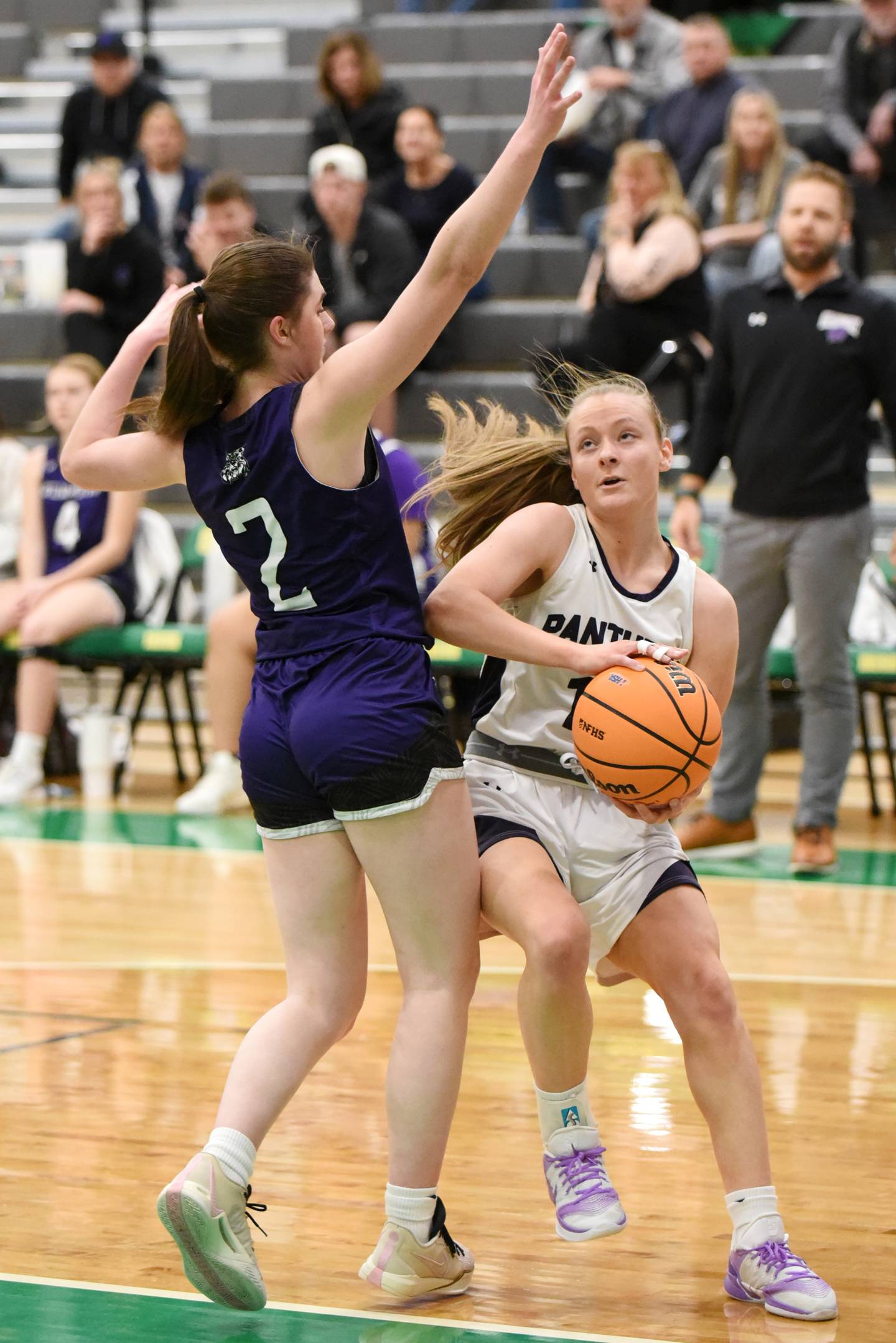 Manteno's Alyssa Singleton, right, drives to the basket as Wilmingon's Sami Liaromatis defends during the IHSA Class 2A Seneca Regional championship Thursday, Feb. 19, 2026.