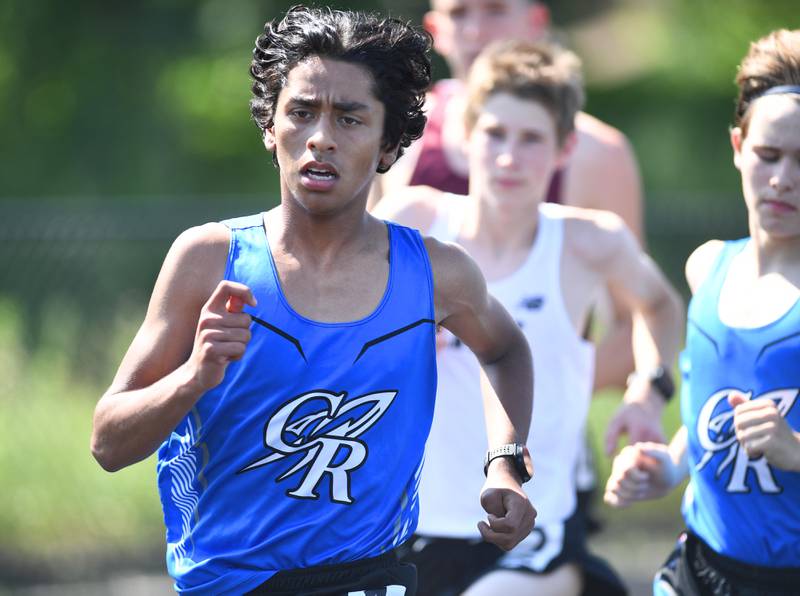 Burlington Central's Yusuf Baig leads the 3,200-meter run at a Class 2A boys track sectional meet in Glen Ellyn on Thursday, June 10, 2021.