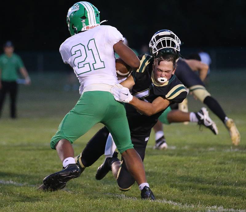 St. Bede's AJ Hermes helmet comes off as he tries to bring down Ridgewood's Julian Luna on Friday, Sept. 15, 2023 at St. Bede Academy.