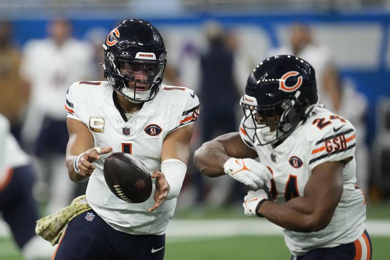 Chicago Bears quarterback Justin Fields hands off to running back Khalil Herbert during the first half against the Detroit Lions, Sunday, Nov. 19, 2023, in Detroit.