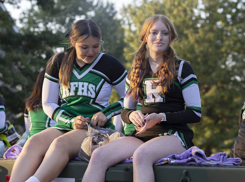 Cheer squad members look for candy targets Thursday, October 10, 2024, during the Rock Falls homecoming parade.