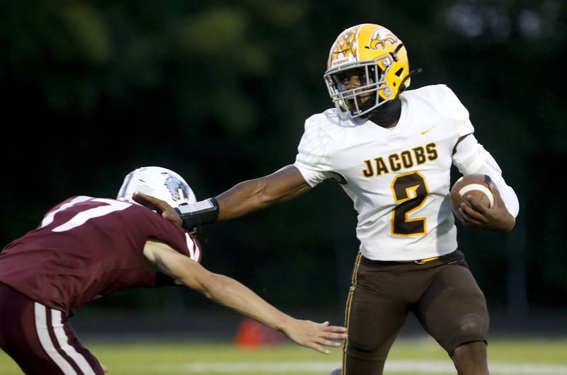 Jacobs' Antonio Brown stiff arms Prairie Ridge's Logan Harlow as he runs for a touchdown during a Fox Valley Conference football game between Jacobs and Prairie Ridge Friday, Sept. 16, 2022, at Jacobs High School in Algonquin.