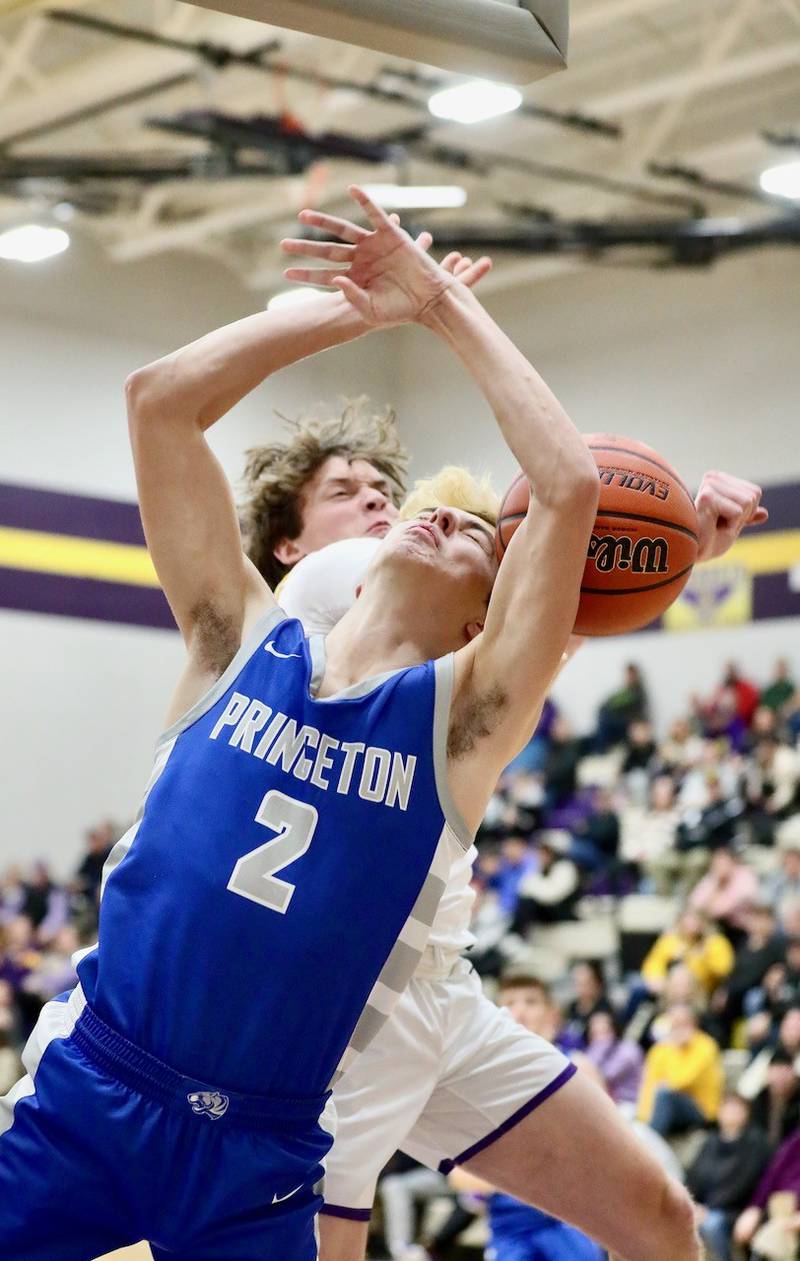 Mendota's Logan Dewey swats the ball away from Princeton's Landon Roarke Friday night at Mendota. The Tigers won 60-47.