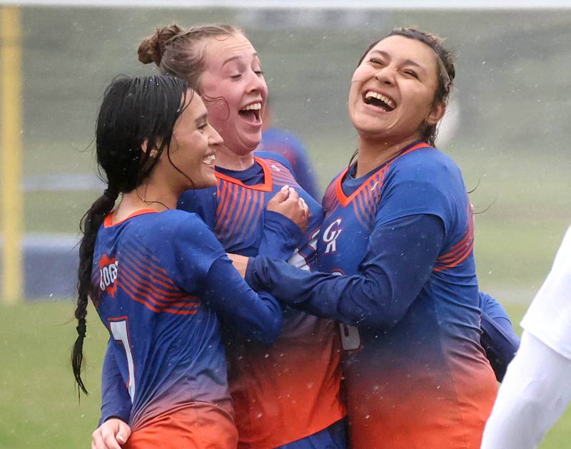 Genoa-Kingston players Jaida Modesto, (left) Ally Poegel and Jaquey Flores (right) celebrate after Poegel scored to put her team up 2-0 in their Class 2A regional final game against Rockford Christian Tuesday, May 20, 2025, at Rockford Christian High School.