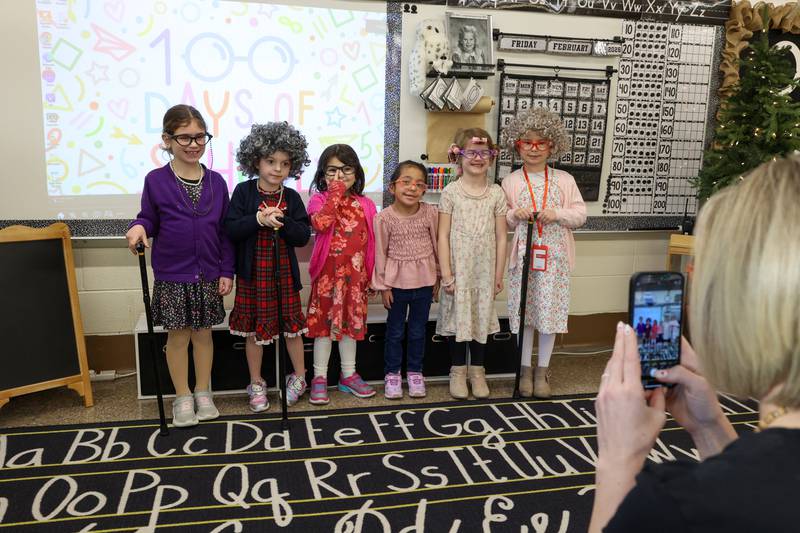 Shabbona Elementary School kindergartener girls in Randi Martin's class gather for a photo in their 100-year-old outfits during the 100th day of school on Monday, Feb. 9, 2026.