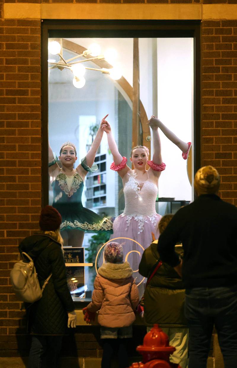Dancers from the Beth Fowler School of Dance perform in the window of MC Beauty Salon and Spa Friday, Nov. 21, 2025, during Moonlight Magic in downtown Sycamore.